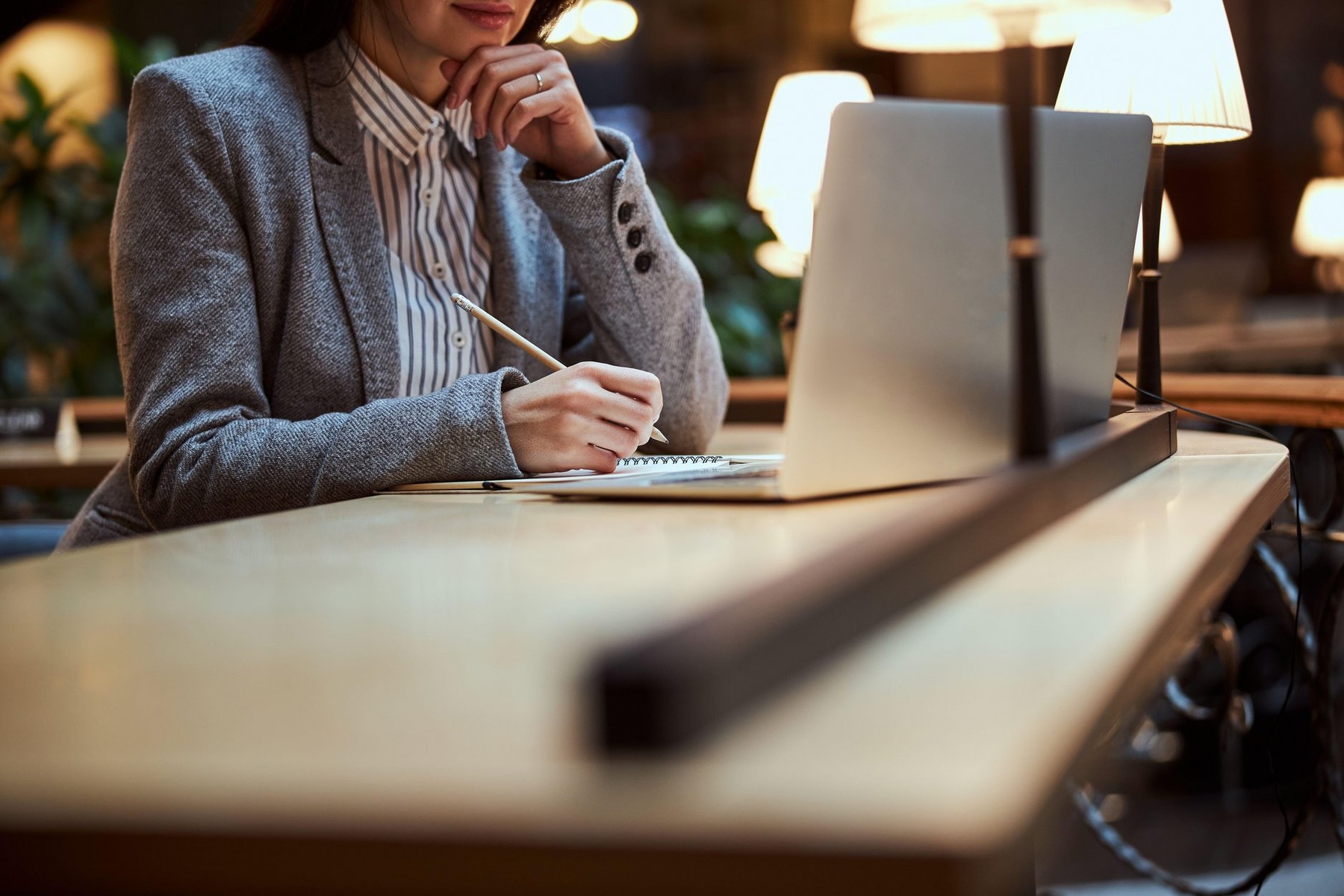 Concentrated brunette sitting at the table and staring at computer during work at project,Image: 594266771, License: Royalty-free, Restrictions: , Model Release: yes, Credit line: Viacheslav Iakobchuk / Alamy / Alamy / Profimedia