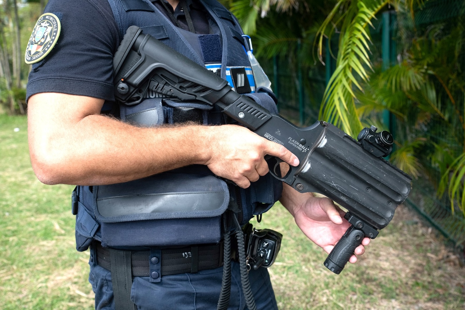 A municipal police officer equipped with flashballs keep watch near the N'Gea traffic circle, where activists are gathered, in Noumea on May 15, 2024, amid protests linked to a debate on a constitutional bill aimed at enlarging the electorate for upcoming elections of the overseas French territory of New Caledonia.  One person was killed, hundreds more were injured, shops were looted and public buildings torched during a second night of rioting in New Caledonia, authorities said May 15, as anger over constitutional reforms from Paris boiled over.,Image: 873132616, License: Rights-managed, Restrictions: , Model Release: no, Credit line: Delphine Mayeur / AFP / Profimedia