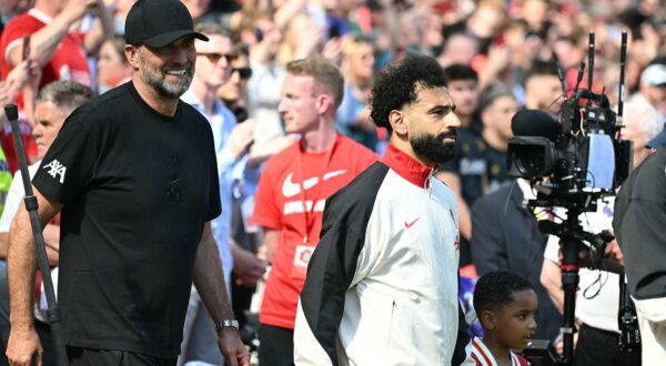 Liverpool's German manager Jurgen Klopp (L) walks out with Liverpool's Egyptian striker #11 Mohamed Salah (C) ahead of kick-off in the English Premier League football match between Liverpool and Wolverhampton Wanderers at Anfield in Liverpool, north west England on May 19, 2024. Jurgen Klopp said Friday he has experienced the "most intense" week of his life as he prepares to bring down the curtain on his trophy-filled Liverpool reign. Klopp, who arrived at the club in October 2015, won seven major trophies at Liverpool, including the club's first league title for 30 years and the 2019 Champions League.,Image: 874475889, License: Rights-managed, Restrictions: RESTRICTED TO EDITORIAL USE. No use with unauthorized audio, video, data, fixture lists, club/league logos or 'live' services. Online in-match use limited to 120 images. An additional 40 images may be used in extra time. No video emulation. Social media in-match use limited to 120 images. An additional 40 images may be used in extra time. No use in betting publications, games or single club/league/player publications., Model Release: no, Credit line: Paul ELLIS / AFP / Profimedia