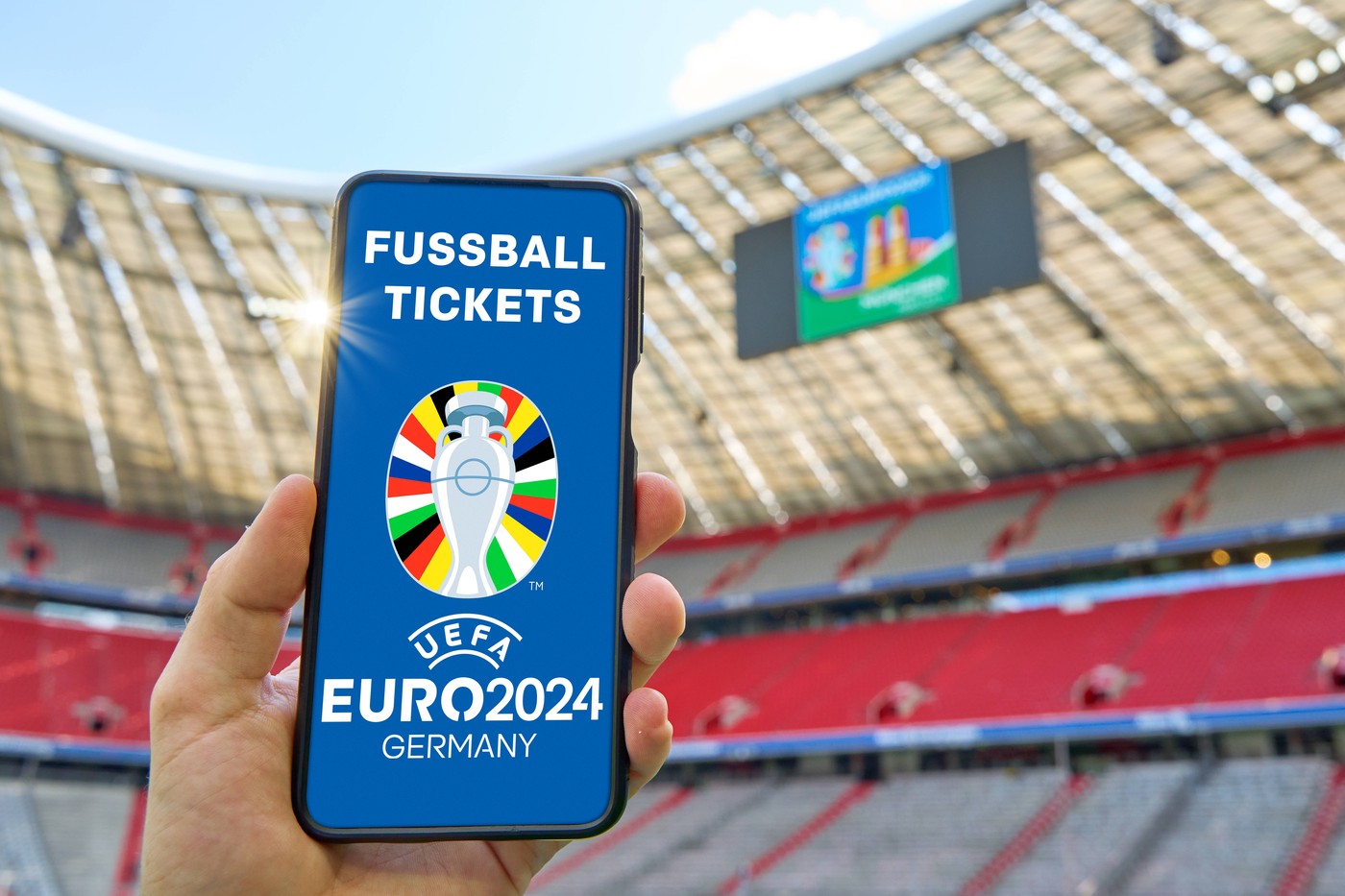 20 May 2024: Hand holding smartphone in soccer stadium with the UEFA EURO, EM, Europameisterschaft,Fussball 2024 logo and the lettering: Football Tickets. Symbolic image of tickets for the European Championship, EM, Europameisterschaft 2024. PHOTOMONTAGE *** Hand hält Smartphone in Fußball Stadion mit dem UEFA EURO 2024 Logo und dem Schriftzug: Fussball Tickets. Symbolbild Eintrittskarten für die Europameisterschaft 2024. FOTOMONTAGE,Image: 874919133, License: Rights-managed, Restrictions: Credit images as "Profimedia/ IMAGO", Model Release: no, Credit line: IMAGO / imago sportfotodienst / Profimedia
