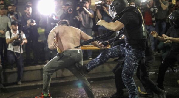 epa11311667 An opposition party supporter clashes with riot police during a protest against a draft bill on 'foreign agents' near the Parliament in Tbilisi, Georgia, 01 May 2024. The Georgian Parliament, against the backdrop of mass protests in Tbilisi, adopted the bill on foreign agents on the first reading. The second reading was appointed on 30 April. For 16 days, opponents of the bill have been gathering in front of the Georgian Parliament and blocking Rustaveli Avenue. Today they also wanted to surround the building to prevent the deputies from leaving it, but the police are preventing this.  EPA/DAVID MDZINARISHVILI