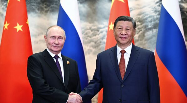epa11343937 Russian President Vladimir Putin (L) and Chinese President Xi Jinping shake hands as they pose for photos before a meeting in narrow format at the Great Hall of the People in Beijing, China, 16 May 2024. The Russian president is on an official visit to China on 16 and 17 May.  EPA/SERGEY GUNEEV / SPUTNIK / KREMLIN POOL MANDATORY CREDIT