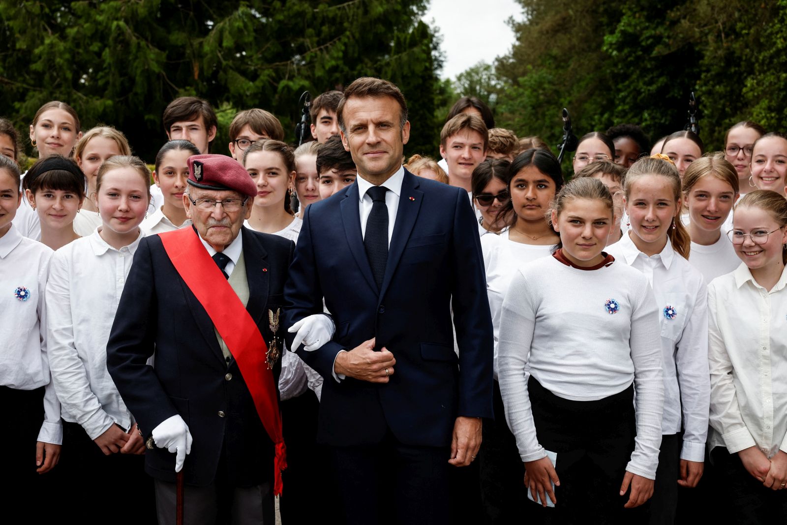 epa11391162 French President Emmanuel Macron (C) and Achille Muller (C-L), the last survivor of the Free French Forces, attend a ceremony to pay homage to the Saint Marcel maquis, a force of French Resistance fighters during World War II and the French SAS (Special Air Service) paratroopers, in Plumelec, Brittany, north-western France, 05 June 2024. Macron launched the commemoration of the 80th anniversary of D-Day, the Normandy landings of Western Allied forces on 06 June 1944 that initiated the liberation of western Europe during World War II, by paying tribute to the French Resistance fighters.  EPA/BENOIT TESSIER / POOL  MAXPPP OUT