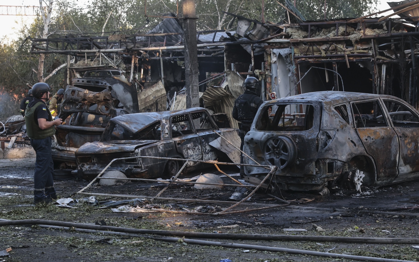 epa11446154 Ukrainian police officers inspect the damage after shelling in Vilniansk, Zaporizhzhia region, southeastern Ukraine, 29 June 2024, amid the Russian invasion. At least seven people have been killed, including two children, and 18 others injured, including four children, after a Russian rocket strike hit the city of Vilniansk, the State Emergency Service of Ukraine (SESU) said. Russian troops entered Ukrainian territory on 24 February 2022, starting a conflict that has provoked destruction and a humanitarian crisis.  EPA/KATERYNA KLOCHKO