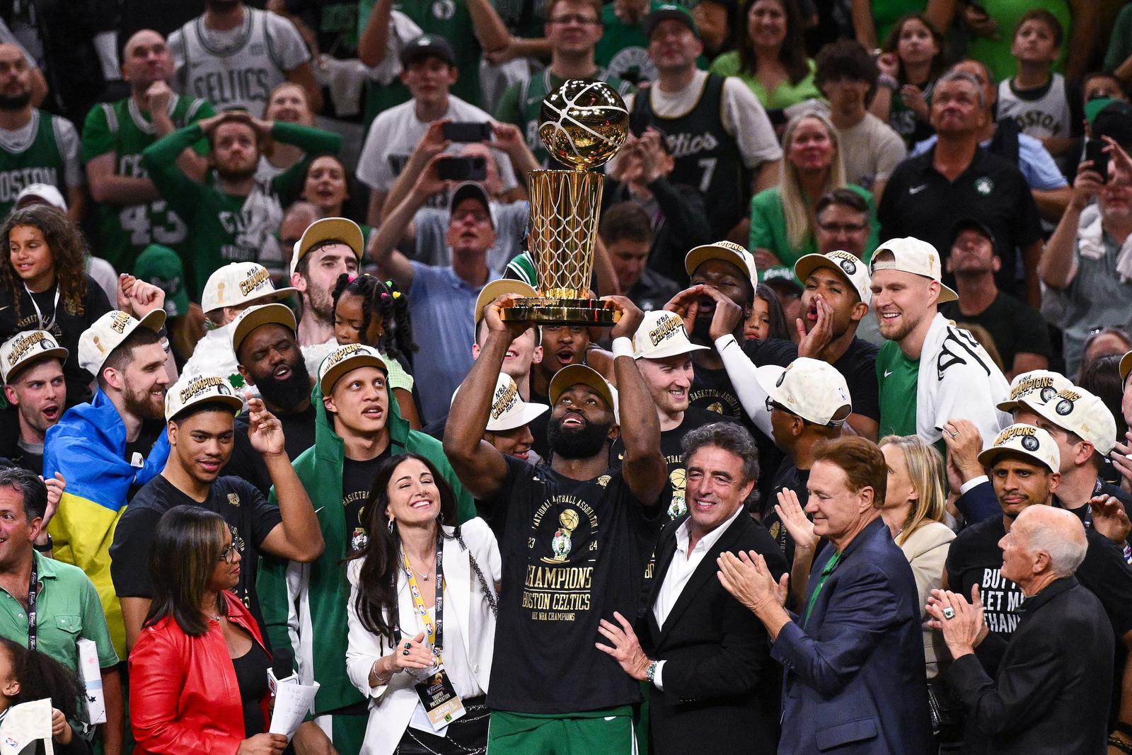 Jun 17, 2024; Boston, Massachusetts, USA; Boston Celtics guard Jaylen Brown (7) holds up the Larry O'Brien Championship Trophy after the Celtics beat the Dallas Mavericks in game five of the 2024 NBA Finals at the TD Garden. Mandatory Credit: Brian Fluharty-USA TODAY Sports Photo: Brian Fluharty/REUTERS