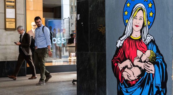 epa11401649 People walk near "Santa Giorgia", a new artwork by Alexsandro Palombo, which appeared last night on a wall in Piazza San Babila in Milan, Italy, 10 June 2024. The mural was created after the victorious result of Giorgia Meloni of the Center Right in the European elections.  EPA/Andrea Fasani