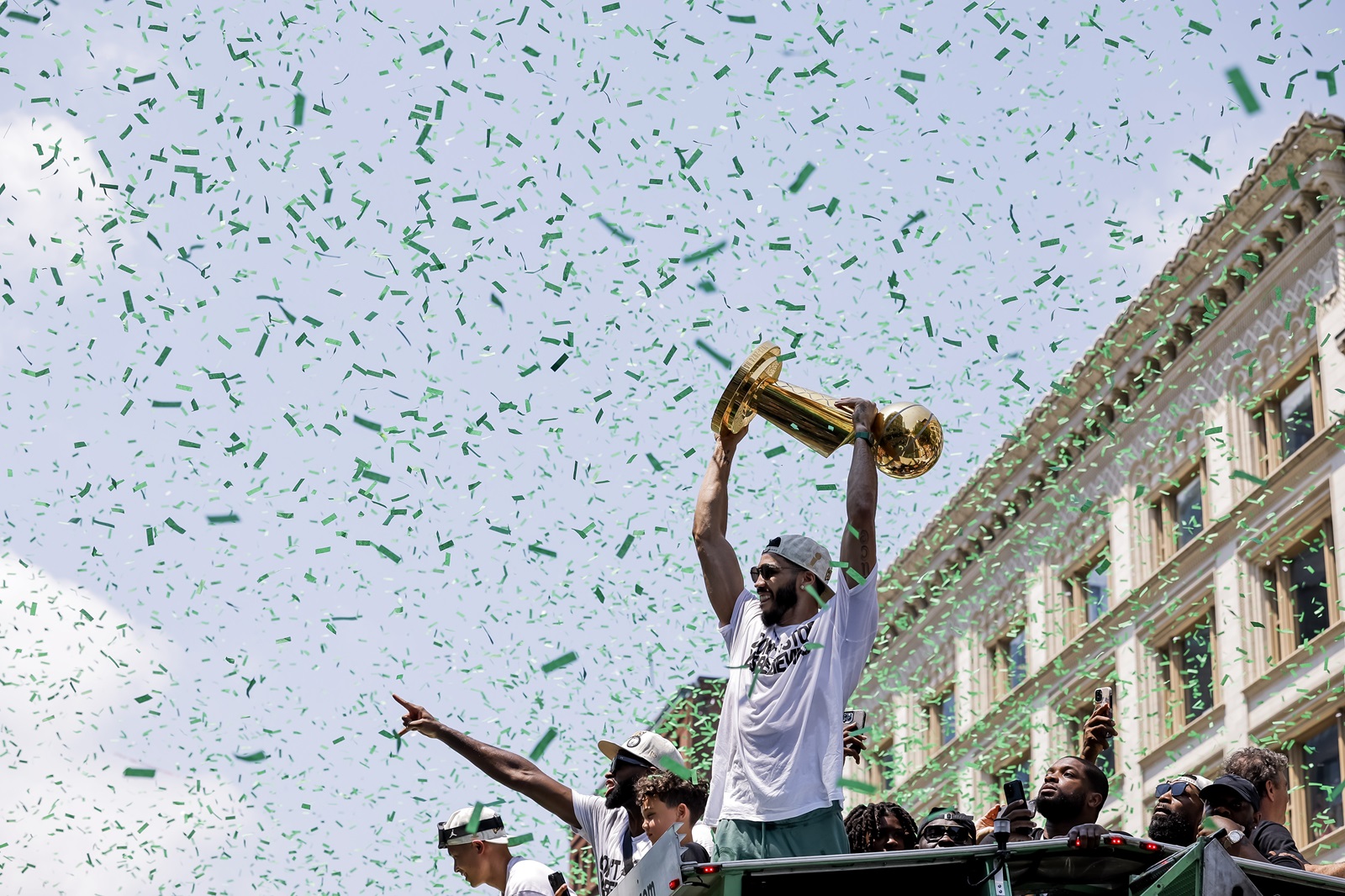 epa11429190 Boston Celtics forward Jayson Tatum holds the Larry O'Brien Trophy as he participates in the team's NBA Championship parade in Boston, Massachusetts, USA, 21 June 2024. The Celtics defeated the Dallas Mavericks in five games for the team's record 18th NBA Championship triumph.  EPA/CJ GUNTHER