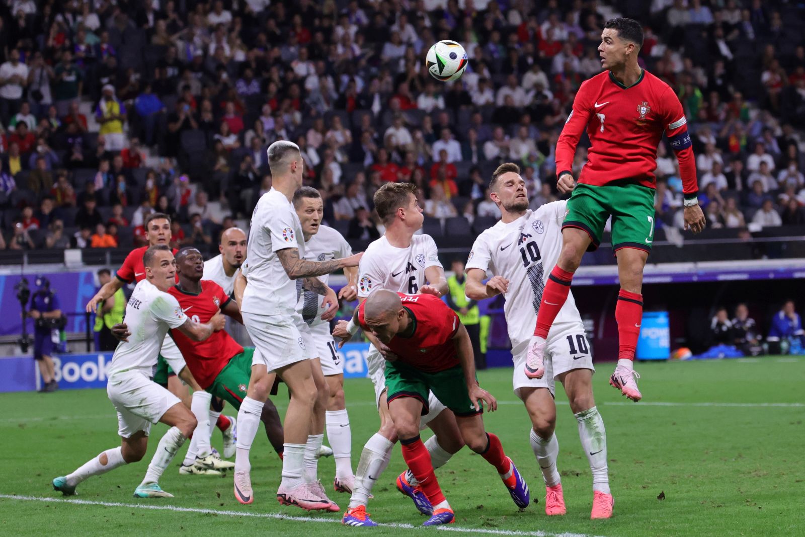 epa11451249 Cristiano Ronaldo of Portugal (R) in action during the UEFA EURO 2024 Round of 16 soccer match between Portugal and Slovenia, in Frankfurt Main, Germany, 01 July 2024.  EPA/OLIVIER MATTHYS