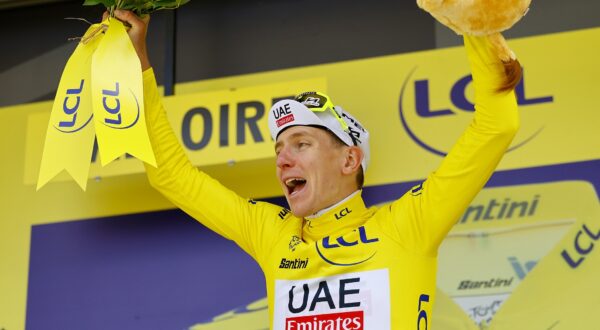 epa11452659 Slovenian rider Tadej Pogacar of UAE Team Emirates celebrates in the overall leader's yellow jersey on the podium after winning the fourth stage of the 2024 Tour de France cycling race over 139km from Pinerolo to Valloire, France, 02 July 2024.  EPA/KIM LUDBROOK