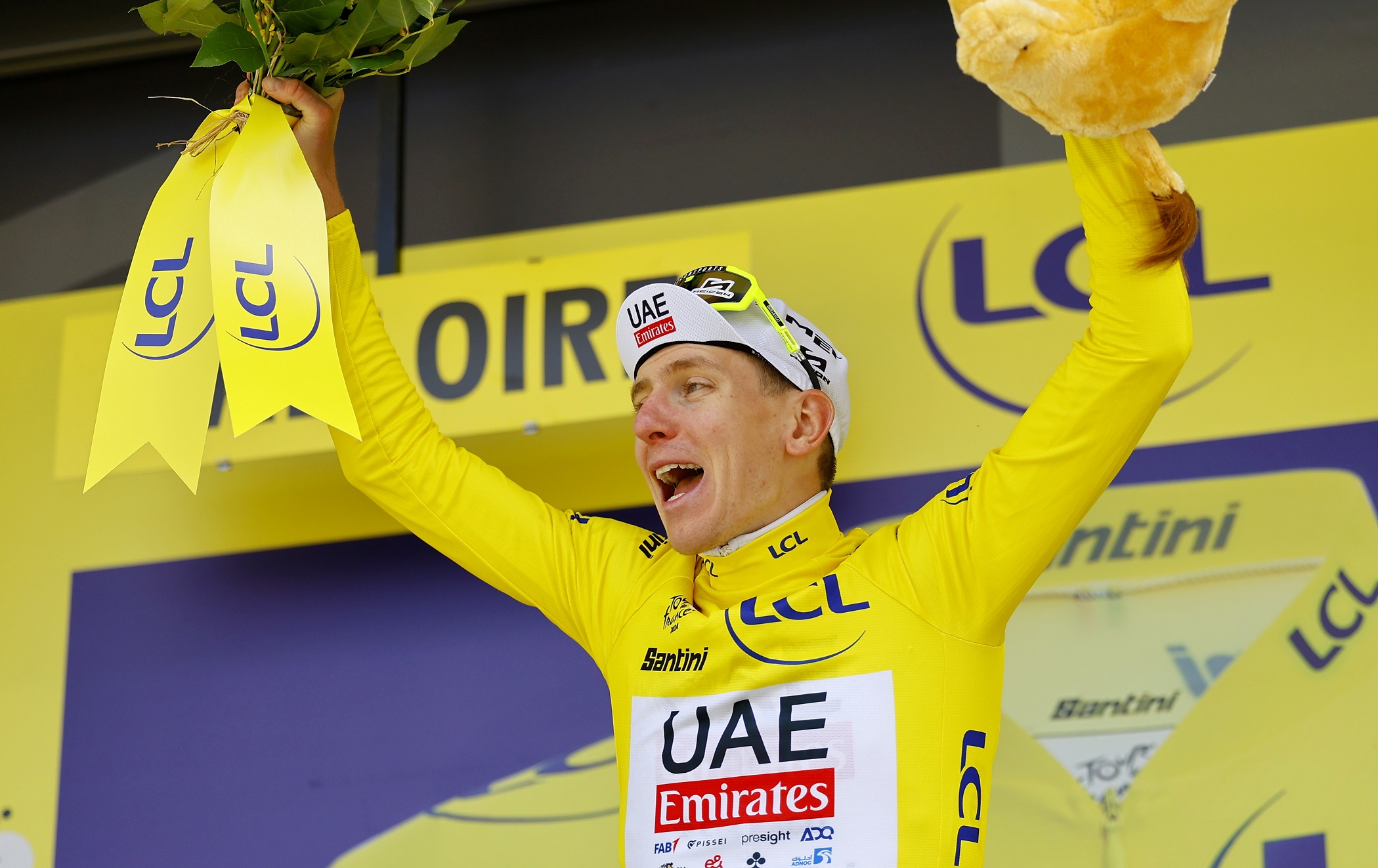 epa11452659 Slovenian rider Tadej Pogacar of UAE Team Emirates celebrates in the overall leader's yellow jersey on the podium after winning the fourth stage of the 2024 Tour de France cycling race over 139km from Pinerolo to Valloire, France, 02 July 2024.  EPA/KIM LUDBROOK