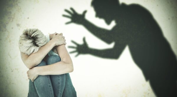 Depressed woman hiding her head  against silhouette of shouting man,Image: 267917909, License: Royalty-free, Restrictions: , Model Release: yes, Credit line: - / Wavebreak / Profimedia
