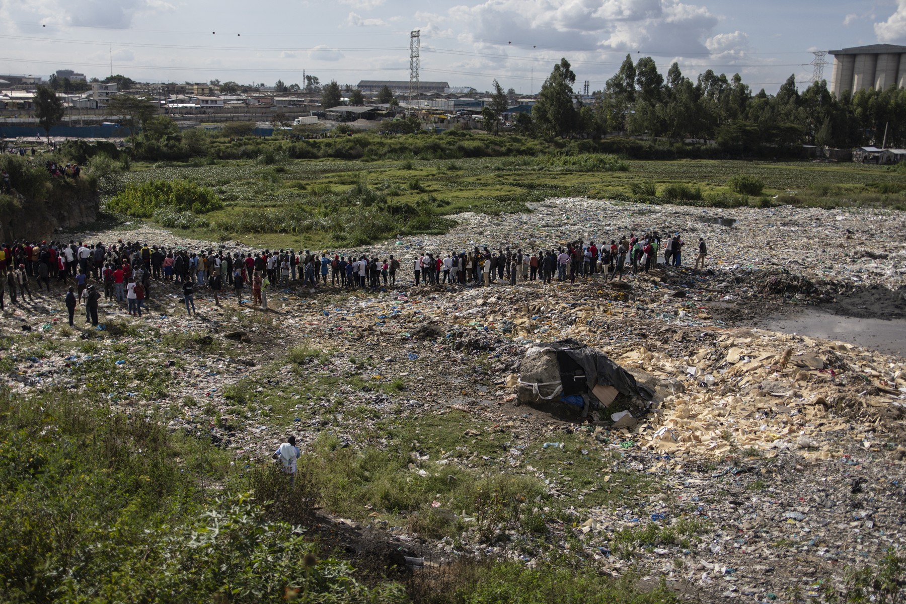 People stand at a dumpsite where six bodies were found in the landfill in Mukuru slum, Nairobi, on July 12, 2024. Kenyan police have announced the opening of an investigation after the discovery of six bodies in a landfill in the capital Nairobi on Friday.
Police briefly fired tear gas and rubber bullets to disperse an angry crowd surrounding a police station near the site of the grisly discovery in Mukuru, a slum in the south of the capital.,Image: 889305611, License: Rights-managed, Restrictions: “The erroneous mention[s] appearing in the metadata of this photo by SIMON MAINA has been modified in AFP systems in the following manner: [six bodies] instead of [nine bodies]. Please immediately remove the erroneous mention[s] from all your online servic, Model Release: no, Credit line: SIMON MAINA / AFP / Profimedia