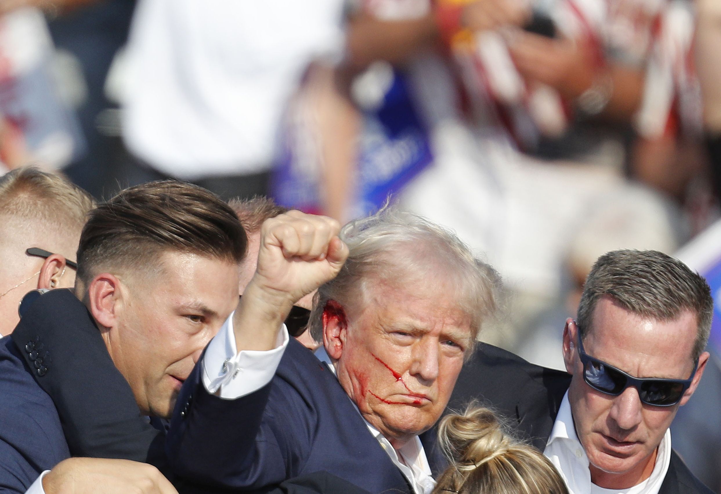 epa11476744 Former US President Donald Trump is rushed off stage by secret service after an incident during a campaign rally at the Butler Farm Show Inc. in Butler, Pennsylvania, USA, 13 July 2024.  EPA/DAVID MAXWELL