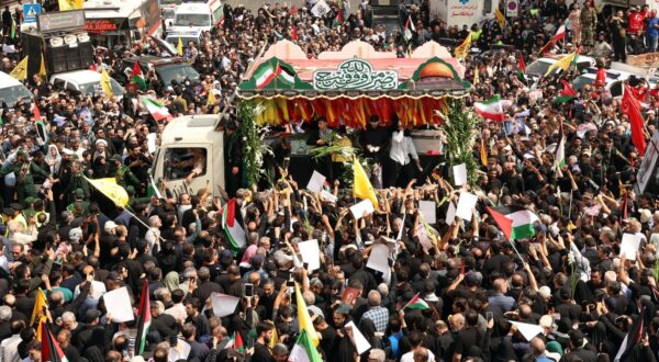epa11514215 People gather as the coffins of Hamas late political leader Ismail Haniyeh and his bodyguard are carried on the back of a truck during a funeral procession in Tehran, Iran, 01 August 2024. Haniyeh and one of his bodyguards were targeted and killed in Tehran on 31 July 2024, the Iranian Revolutionary Guard Corps (IRGC) confirmed.  EPA/ABEDIN TAHERKENAREH