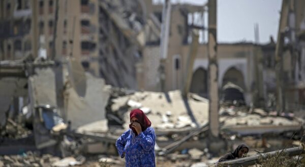 epa11572798 A Palestinian woman inspects her destroyed house after she return to Deir Al Balah town after the Israeli military pulled out troops from the east central Gaza Strip, 29 August 2024.More than 40,000 Palestinians and over 1,400 Israelis have been killed, according to the Palestinian Health Ministry and the Israel Defense Forces (IDF), since Hamas militants launched an attack against Israel from the Gaza Strip on 07 October 2023, and the Israeli operations in Gaza and the West Bank which followed it.  EPA/MOHAMMED SABER