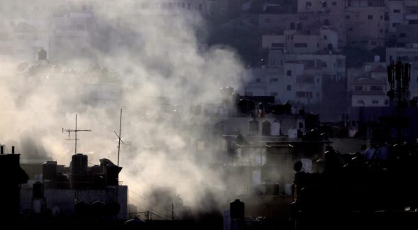 epa11575946 Smokes rises over Jenin camp during heavy clashes on the fourth day of an Israeli military operation in the West Bank city of Jenin, 31 August 2024. According to the Palestinian Health Ministry, at least 20 Palestinians have been killed since Israeli military operations started on 28 August 2024 in the West Bank cities of Tulkarem, Jenin and Tubas. The Israeli army said that it's conducting a large-scale 'counter-terrorism operation' in several areas.  EPA/ALAA BADARNEH