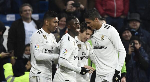 Real Madrid's Croatian midfielder Luka Modric (2L) celebrates with Real Madrid's Brazilian midfielder Casemiro, Real Madrid's Brazilian forward Vinicius Junior and Real Madrid's French defender Raphael Varane after scoring a goal during the Spanish League football match between Real Madrid and Sevilla at the Santiago Bernabeu stadium in Madrid on January 19, 2019.,Image: 408685920, License: Rights-managed, Restrictions: , Model Release: no, Credit line: PIERRE-PHILIPPE MARCOU / AFP / Profimedia