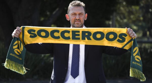 Tony Popovic, the newly-appointed head coach for Australia's national football team, poses with a scarf after a press conference in Sydney on September 23, 2024. Football Australia appointed former Crystal Palace defender Tony Popovic as the new Socceroos coach on September 23, tasking him with rescuing their faltering World Cup qualifying campaign.,Image: 910930579, License: Rights-managed, Restrictions: -- IMAGE RESTRICTED TO EDITORIAL USE - STRICTLY NO COMMERCIAL USE --, Model Release: no, Credit line: DAVID GRAY / AFP / Profimedia