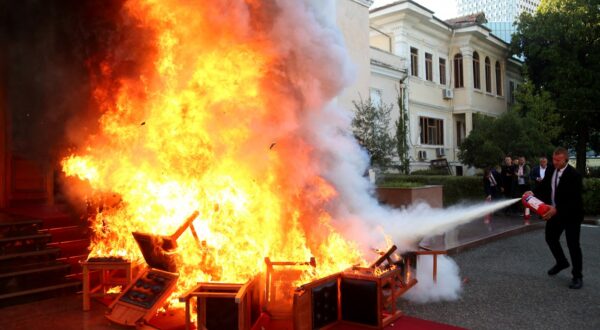 Members of the National Guard extinguish a fire set by opposition MPs by burning their Parliament chairs in front of the Parliament in protest of the arrest of their colleague opposition MP Ervin Salianji in Tirana on September 30, 2024. Leader of centre-right Democratic Party, Ervin Salianji was sentenced to one-year imprisonment and convicted of "giving false evidence" in a drug trafficking case involving the brother of a Socialist MP. Judges suspected certain members of the opposition of having produced false recordings.,Image: 914242360, License: Rights-managed, Restrictions: , Model Release: no, Credit line: ADNAN BECI / AFP / Profimedia