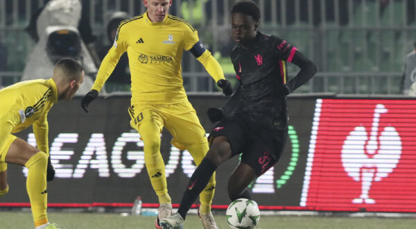 Chelsea's Tyrique George, right, fights for the ball with Astana's Marin Tomasov during the Europa Conference League opening phase soccer match between Astana and Chelsea at the Almaty Ortalyk stadium in Almaty, Kazakhstan, Thursday, Dec. 12, 2024. (AP Photo)