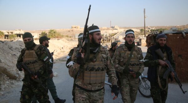 epa11750162 Opposition fighters patrol the streets after they took control of the city of Maarat al-Numan where the international road M5 passes through it, in Maarat al-Numan, Syria, 30 November 2024, following a large offensive by rebel forces November 27, taking large parts of the country's second-biggest city. The offensive triggered Russian strikes on Aleppo 30 November 2024, the first since 2016, and saw Syria's military withdraw its troops from the city. The attack was led by the Islamist militant group Hayat Tahrir al-Sham (HTS).  EPA/BILAL AL HAMMOUD