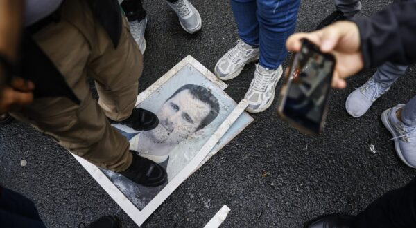 A demonstrator stands on a photograph of President Bashar al-Assad during a protest outside the Syrian consulate in Istanbul on December 8, 2024. Syria's capital woke up on December 8, 2024 to chanting, cheering and gunfire in celebration of the fall of President Bashar al-Assad, after rebels said they entered the city and toppled the longtime ruler. Rebel group Hayat Tahrir al-Sham and allied factions have pressed a lightning offensive since November 27, sweeping swathes of the country from government control, including major cities Aleppo, Hama and Homs and entering the capital Damascus early Sunday.,Image: 944329703, License: Rights-managed, Restrictions: , Model Release: no, Credit line: KEMAL ASLAN / AFP / Profimedia