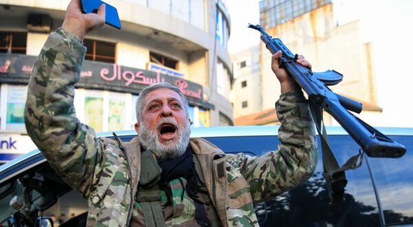A Syrian rebel fighter who returned to the central city of Homs on December 8, 2024, after being in exile for 12 years celebrates after rebel forces entered Syria's third city overnight. Islamist-led rebels declared that they have taken Damascus in a lightning offensive on December 8, sending President Bashar al-Assad fleeing and ending five decades of Baath rule in Syria.,Image: 944295688, License: Rights-managed, Restrictions: , Model Release: no, Credit line: Aref TAMMAWI / AFP / Profimedia