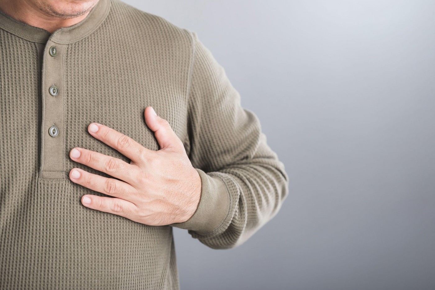 A man touches his left chest, indicating pain that may signal heart or cardiovascular issues. Image emphasizes the importance of early detection and awareness in preventing heart-related health risks,Image: 942058392, License: Royalty-free, Restrictions: , Model Release: no, Credit line: Phanuwat Nandee / Alamy / Alamy / Profimedia