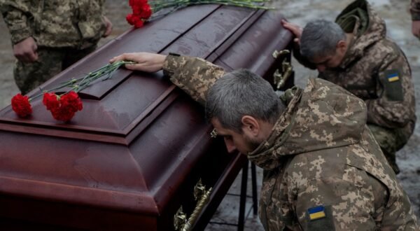 Ukrainian army members mourn next to the coffin of Pavlo Vedybida, callsign "Obolonchyk", a Ukrainian serviceman and ultras member of Football Club Obolon Kyiv, who was killed in the battle near the town of Chasiv Yar, Donetsk region, during the funeral ceremony at a cemetery in Kyiv on November 30, 2024, amid the Russian invasion of Ukraine.,Image: 941278829, License: Rights-managed, Restrictions: , Model Release: no, Credit line: Tetiana DZHAFAROVA / AFP / Profimedia