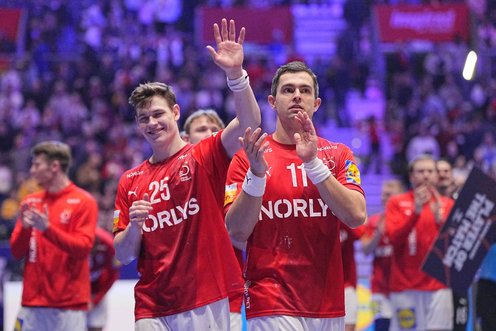 epa11861039 Denmark's Lukas Jorgensen (L) and Rasmus Lauge celebrate after winning the IHF Men's Handball World Championship quarterfinal match between Denmark and Brazil at Unity Arena in Oslo, Norway, 29 January 2025.  EPA/Bo Amstrup  DENMARK OUT