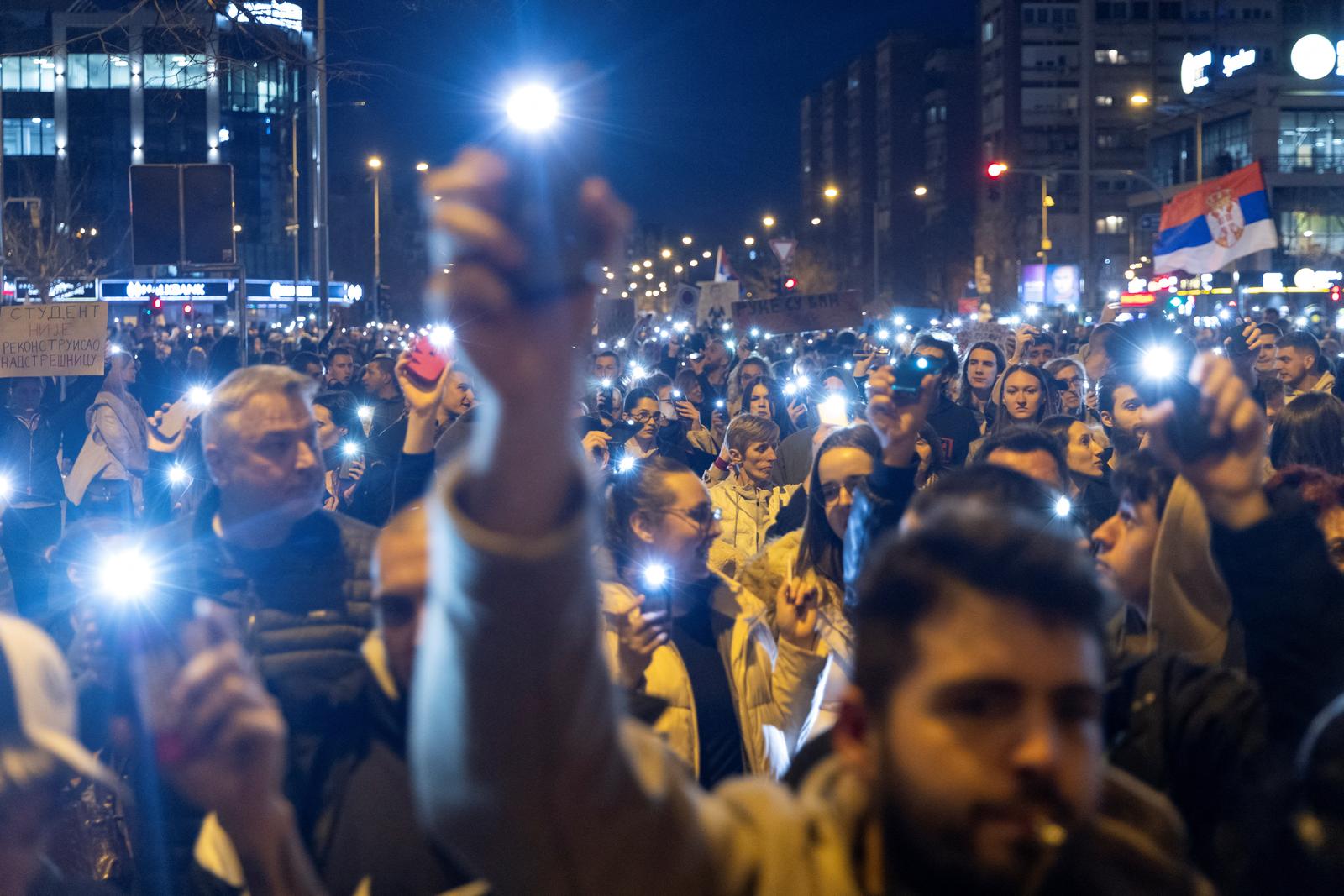 Serbian students light up their mobile phones during a protest in front of the ruling Serbian Progressive Party (SNS) headquarters following the overnight beating of their colleagues by what they say were SNS activists, in Novi Sad, Serbia, January 28, 2025. REUTERS/Mitar Mitrovic NO RESALES. NO ARCHIVES Photo: Mitar Mitrovic/REUTERS