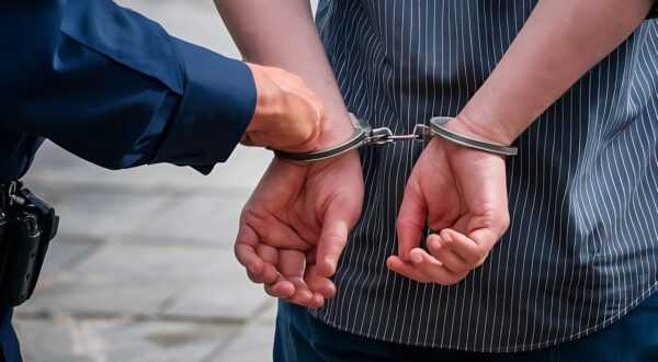 a policeman is handcuffing a criminal,Image: 887038239, License: Royalty-free, Restrictions: , Model Release: no, Credit line: Rony Tarmidi rony / Panthermedia / Profimedia