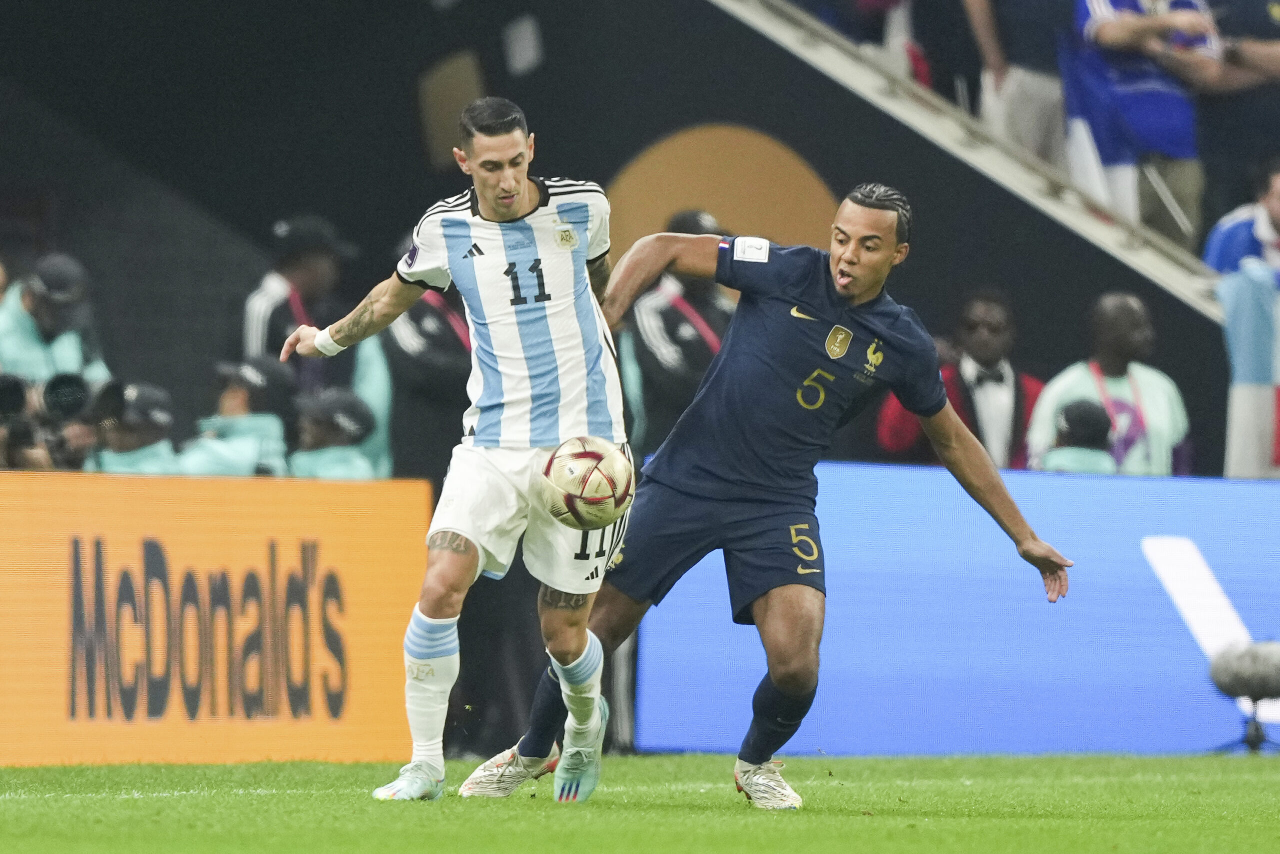 LUSAIL, QATAR - DECEMBER 18: Player of Argentina Ángel Di María fights for the ball with player of France Jules Koundé during the FIFA World Cup Qatar 2022 Final match between Argentina and France at Lusail Stadium on December 18, 2022 in Lusail, Qatar. (Photo by Florencia Tan Jun/PxImages/Icon Sportswire) (Icon Sportswire via AP Images)