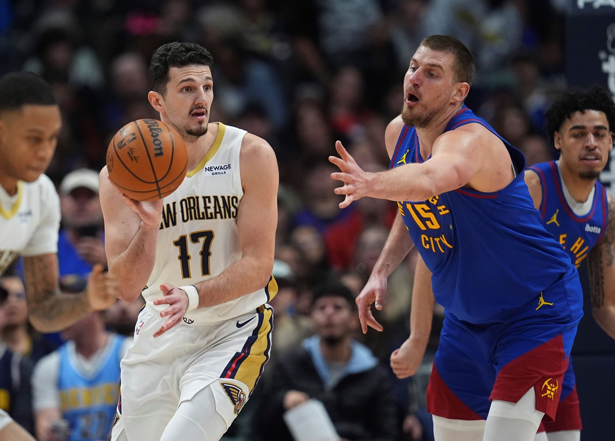 New Orleans Pelicans center Karlo Matkovic (17) looks to pass the ball as Denver Nuggets center Nikola Jokic (15) defends in the second half of an NBA basketball game Monday, Feb. 3, 2025, in Denver. (AP Photo/David Zalubowski) Pelicans Nuggets Basketball