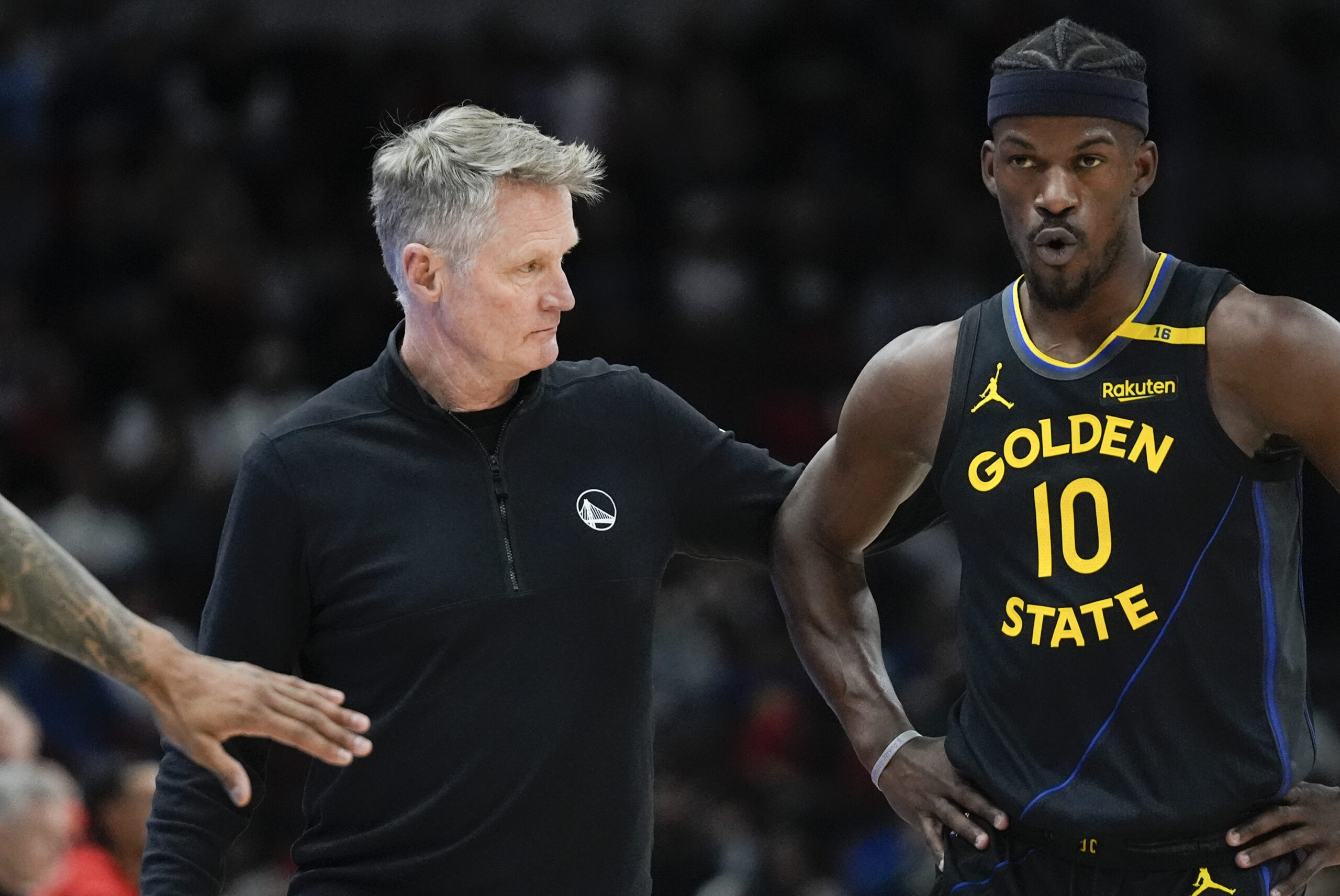 Golden State Warriors head coach Steve Kerr, left, pats Warriors forward Jimmy Butler (10) on the back during the first half of an NBA basketball game against the Chicago Bulls, Saturday, Feb. 8, 2025, in Chicago. (AP Photo/Erin Hooley)