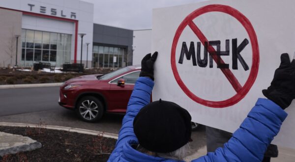 A person holds up a sign during a protest against Elon Musk outside of a Tesla dealership in West Bloomfield, Michigan, on February 27, 2025. During his election campaign, US President Donald Trump promised to slash federal government spending and bureaucracy, a task he bestowed upon his top donor and close advisor Elon Musk, as part of the newly created Department of Government Efficiency (DOGE).,Image: 969828942, License: Rights-managed, Restrictions: , Model Release: no, Credit line: JEFF KOWALSKY / AFP / Profimedia