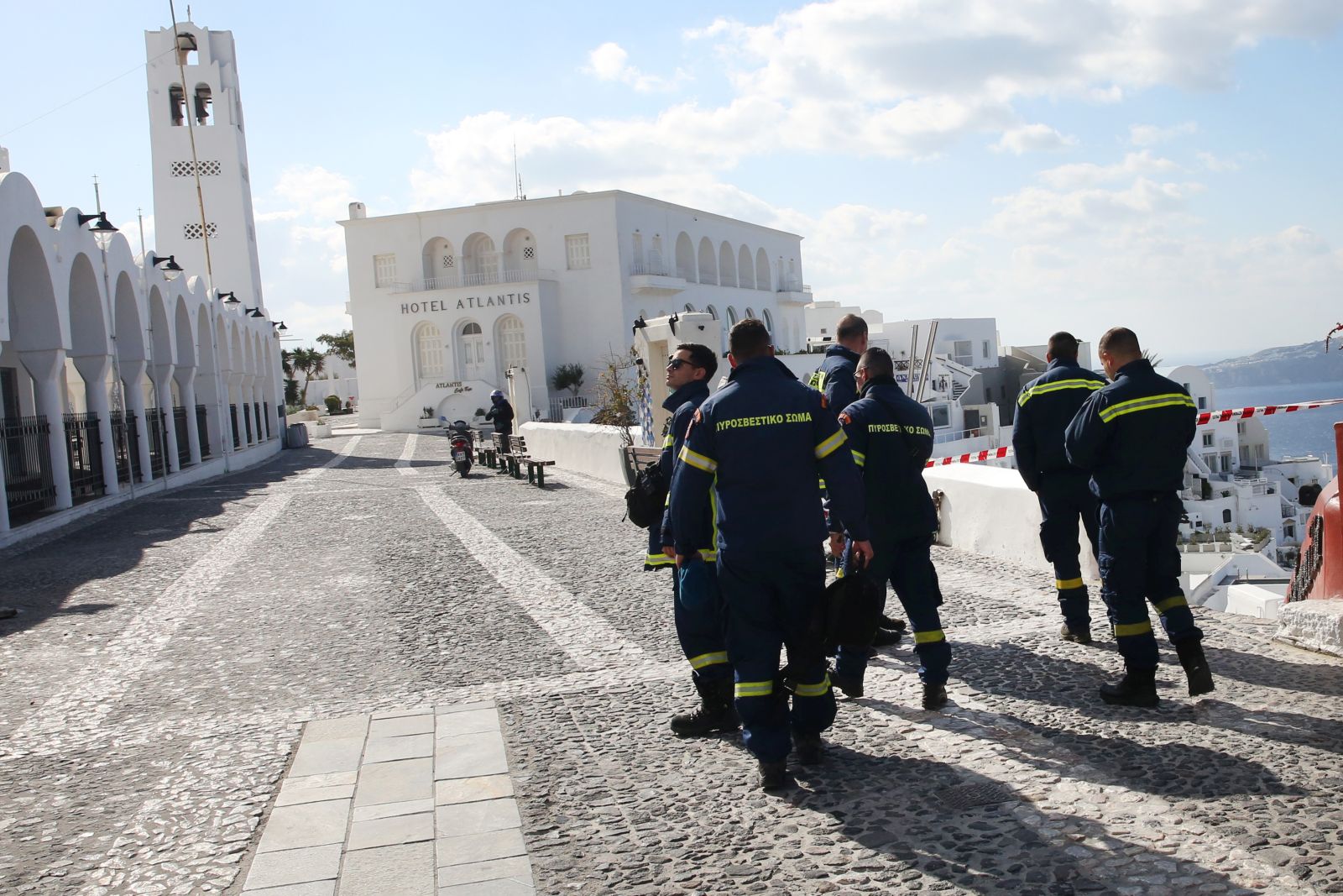 epa11878645 Firefighters walk in the almost evacuated village of Fira in Santorini, Greece, 06 February 2025. The municipality of Thera (Santorini) advised the emptying of water from swimming pools, banned all construction work and forbade access to the Athinio port, except when ships are docking, due to a wave of seismic activity. More than ten earthquakes of over 4.0 magnitude have jolted the region since the night of February 4.  EPA/ORESTIS PANAGIOTOU