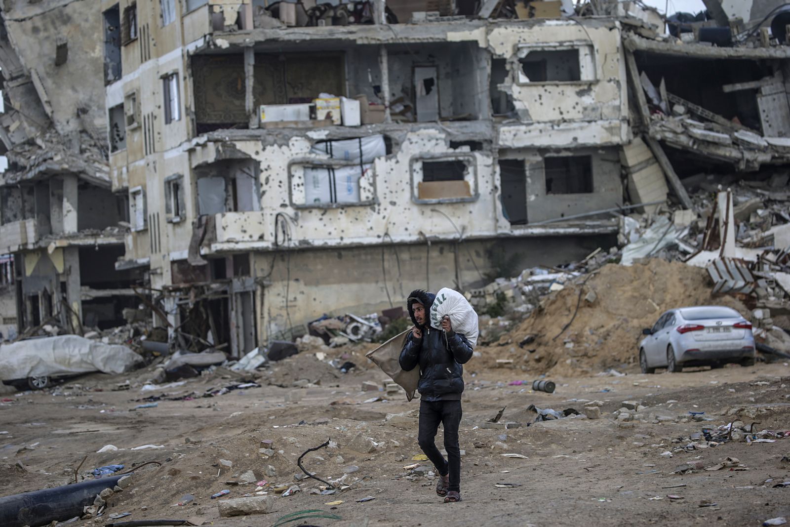epa11878858 A Palestinian man walks past destroyed buildings in the streets of Gaza City amid a ceasefire between Israel and Hamas, Gaza Strip, 06 February 2025. Israel and Hamas implemented the first phase of a hostage release and ceasefire deal on 19 January 2025. More than 46,000 Palestinians have been killed in the Gaza Strip, according to the Palestinian Ministry of Health, since Israel launched a military campaign in the strip in response to a cross-border attack led by the Palestinian militant group Hamas on 07 October 2023, in which about 1,200 Israelis were killed and more than 250 taken hostage.  EPA/MOHAMMED SABER