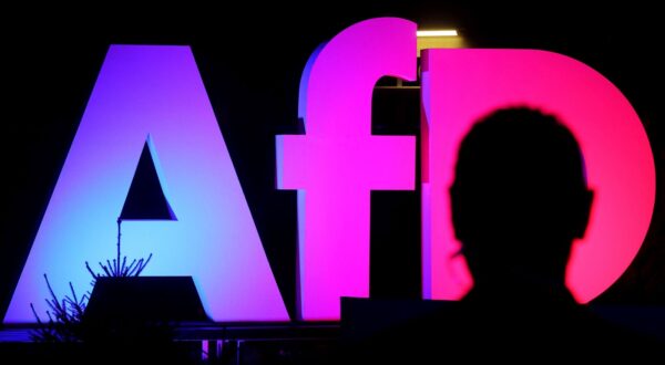epa11919520 An illuminated AFD logo is seen at the Alternative for Germany (AfD) election event in Berlin, Germany, 23 February 2025.  EPA/FILIP SINGER