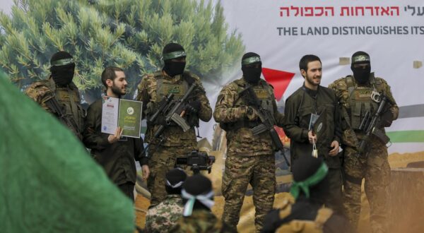 Hamas militants parade newly-released Israeli hostages Omer Shem Tov (L) and Omer Wankert on stage in Nuseirat in the central Gaza Strip, as part of the seventh hostage-prisoner release on February 22, 2025. Three more Israeli hostages were freed by Hamas militants at a ceremony in central Gaza on February 22 after two others were released in the southern part of the Palestinian territory.,Image: 967872950, License: Rights-managed, Restrictions: , Model Release: no, Credit line: Middle East Images/ABACA / Abaca Press / Profimedia