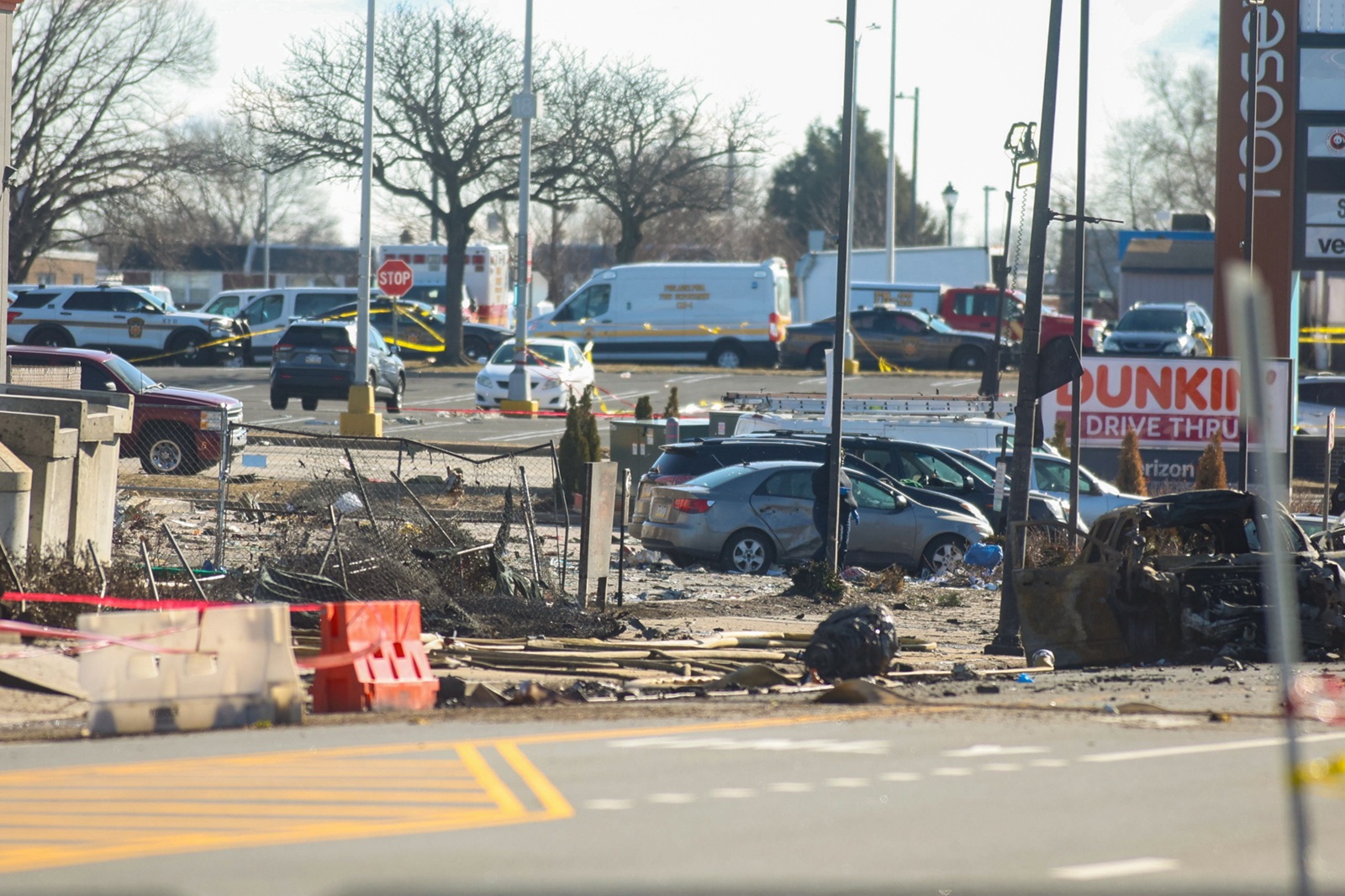 epa11868543 Police and emergency services work at the cordoned-off scene of a plane crash east of Cottman Avenue towards Roosevelt Boulevard in Northeast Philadelphia, USA, 01 February 2025. A statement from the Philadelphia Mayor’s Office confirmed that all six people on board died in the crash on the night of 31 January.  EPA/MIGUEL MARTINEZ