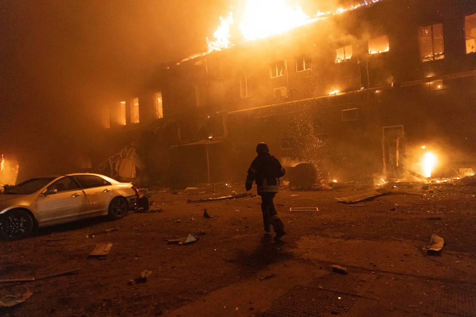January 28, 2025, Kharkiv, Ukraine: One of the firefighter extinguishes a fire after a Russian attack on a civil factory in Kharkiv. An enemy Shahed drone hit the territory of a civilian enterprise. Previously, it was a woodworking shop. After the hit, a gas pipeline was damaged, which was used at the enterprise for production. In connection with this, a large-scale fire broke out, which spread widely. More than 12 units of the State Emergency Service, as well as equipment from the Kharkiv City Council, were involved in extinguishing the fire,' says Gladkikh. The fire completely engulfed the two-story building, a correspondent for Suspilny reports. The premises of neighboring enterprises and at least two cars that were parked nearby were also damaged. According to preliminary data, says Gladkikh, there are no injuries as a result of the explosion and fire.'There is information about two victims, they have an acute reaction to stress. But these are not employees of the enterprise, no one was here when the fire broke out. These are residents of the surrounding areas,' said the director of the department.,Image: 959576534, License: Rights-managed, Restrictions: , Model Release: no, Credit line: Yevhen Titov / Zuma Press / Profimedia