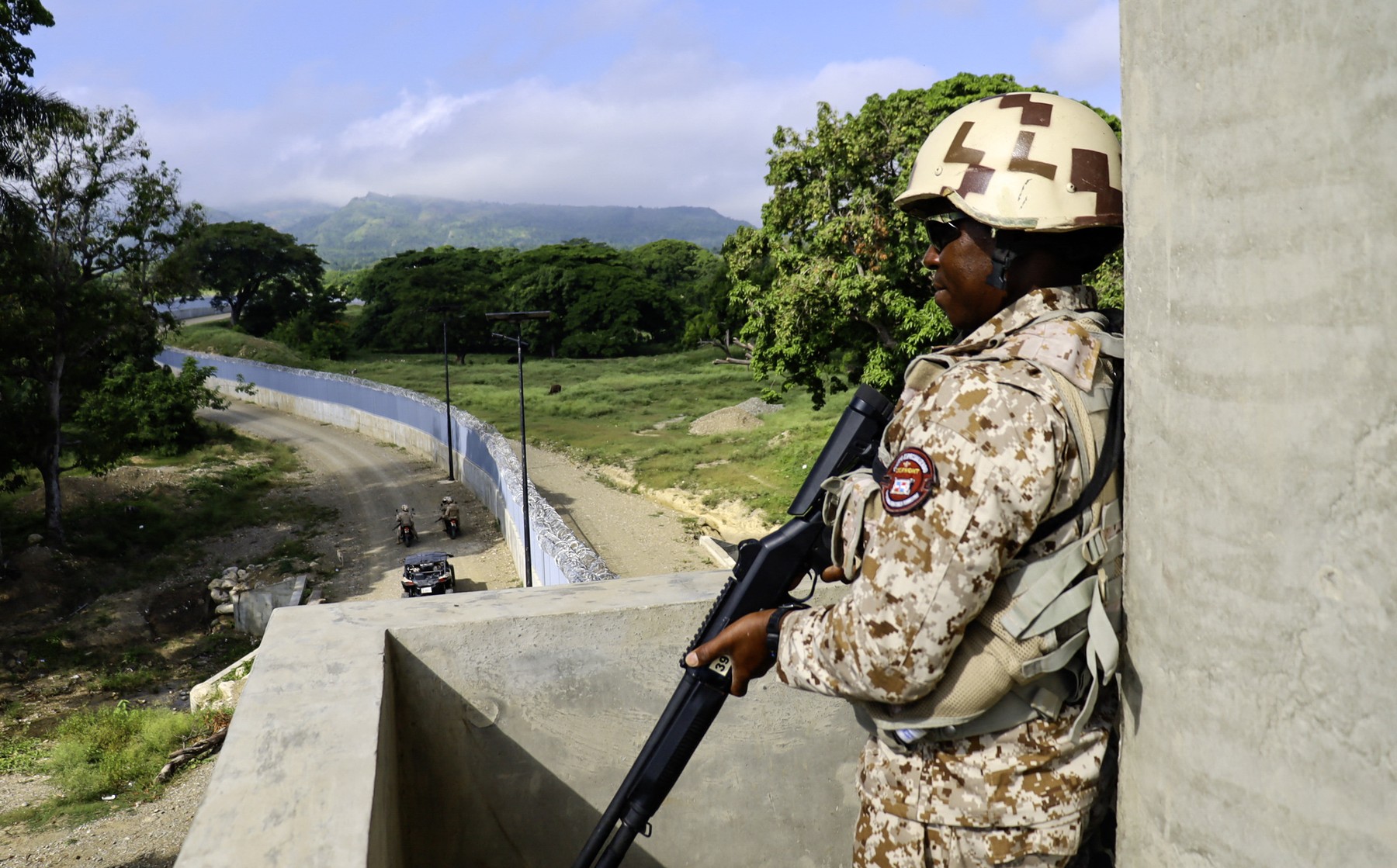 A Dominican Republic soldier stands guard at the border wall built along the Dominican Republic-Haiti border in Pedernales, Dominican Republic, on June 20, 2024.,Image: 883416382, License: Rights-managed, Restrictions: , Model Release: no, Credit line: Erickson POLANCO / AFP / Profimedia
