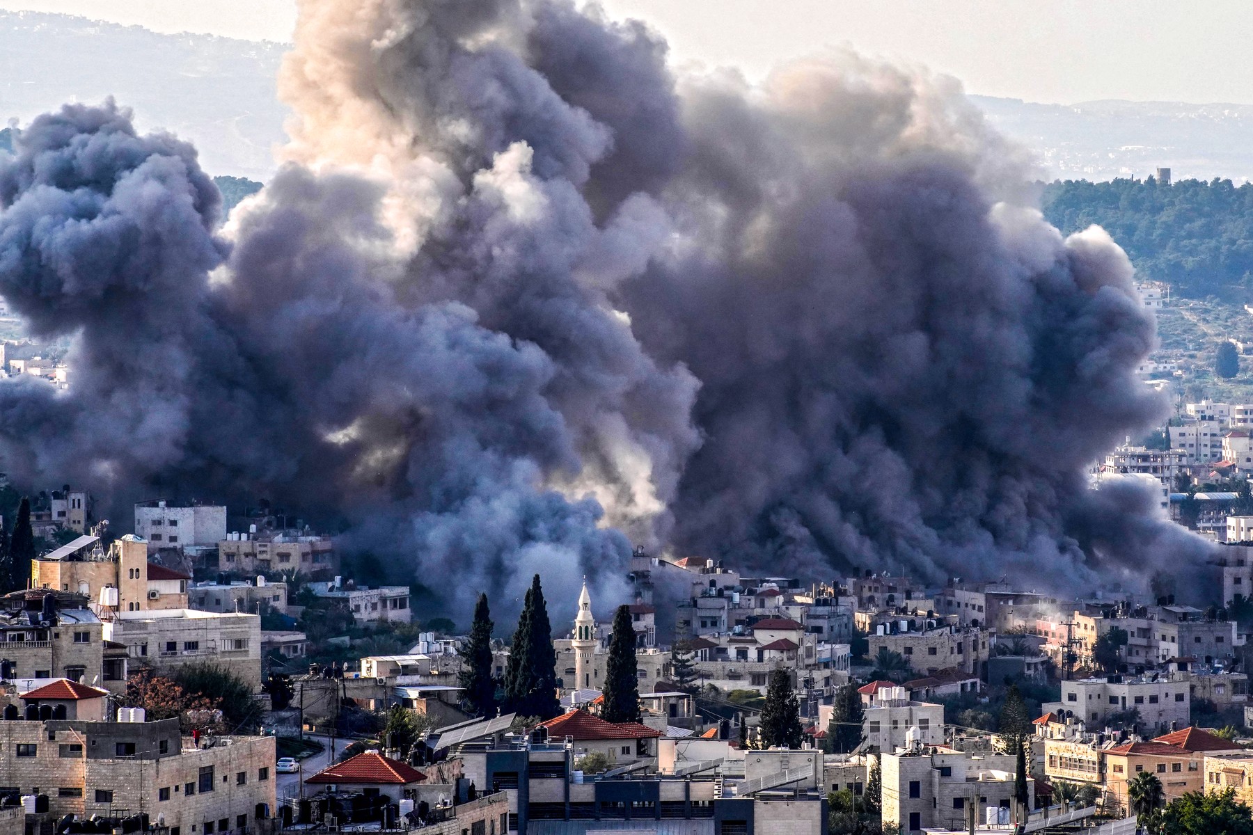 Smoke billows from the site of several explosions during an Israeli raid on the Jenin camp for Palestinian refugees on February 2, 2025. The Israeli military launched a major offensive in the West Bank last month dubbed "Iron Wall" aimed at rooting out Palestinian armed groups from the Jenin area, which has long been a hotbed of militancy.,Image: 959607476, License: Rights-managed, Restrictions: , Model Release: no, Credit line: MOHAMMAD MANSOUR / AFP / Profimedia