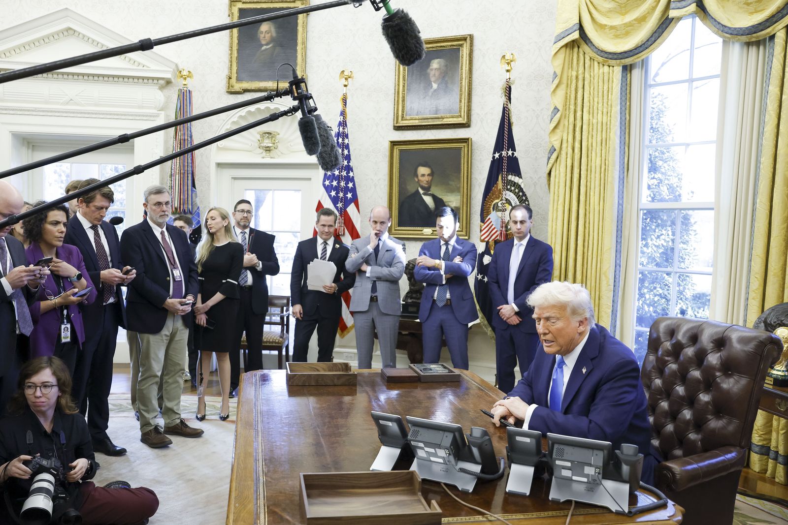 epa11875442 US President Donald Trump talks to reporters as he signs a series of executive orders in the Oval Office of the White House in Washington, DC, USA, 04 February 2025.  EPA/SHAWN THEW / POOL