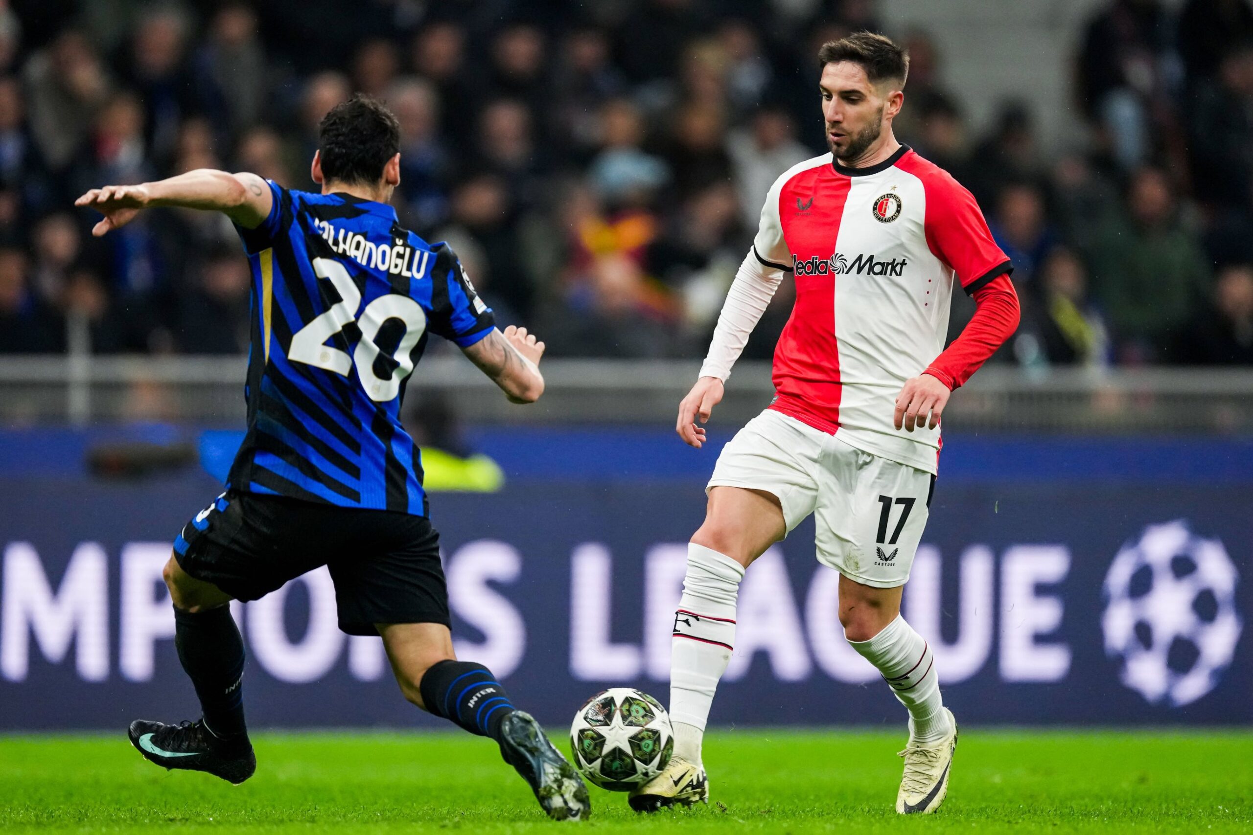 UEFA Champions League: FC Internationale Milan v Feyenoord Milan - Hakan Calhanoglu of FC Inter Milan, Luka Ivanusec of Feyenoord during the 2nd leg of the round of 16 of new format of the Champions League 2024 2025. The match is set between FC Internationale Milan and Feyenoord at Giuseppe Meazza San Siro on 11 March 2025 in Milan, Italy. Copyright: xTomxBodex