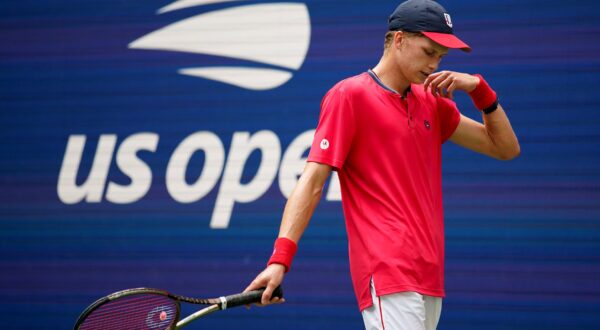 Jenson Brooksby, of the United States, reacts during a match against Carlos Alcaraz, of Spain, during the third round of the U.S. Open tennis championships, Saturday, Sept. 3, 2022, in New York. Brooksby was given an 18-month suspension after an independent tribunal determined he missed three drug tests within the span of a year. Under antidoping rules, athletes can be penalized without a positive test if they have three “whereabout failures” within 12 months. (AP Photo/Eduardo Munoz Alcaraz, File) Brooksby-Doping Suspension Tennis