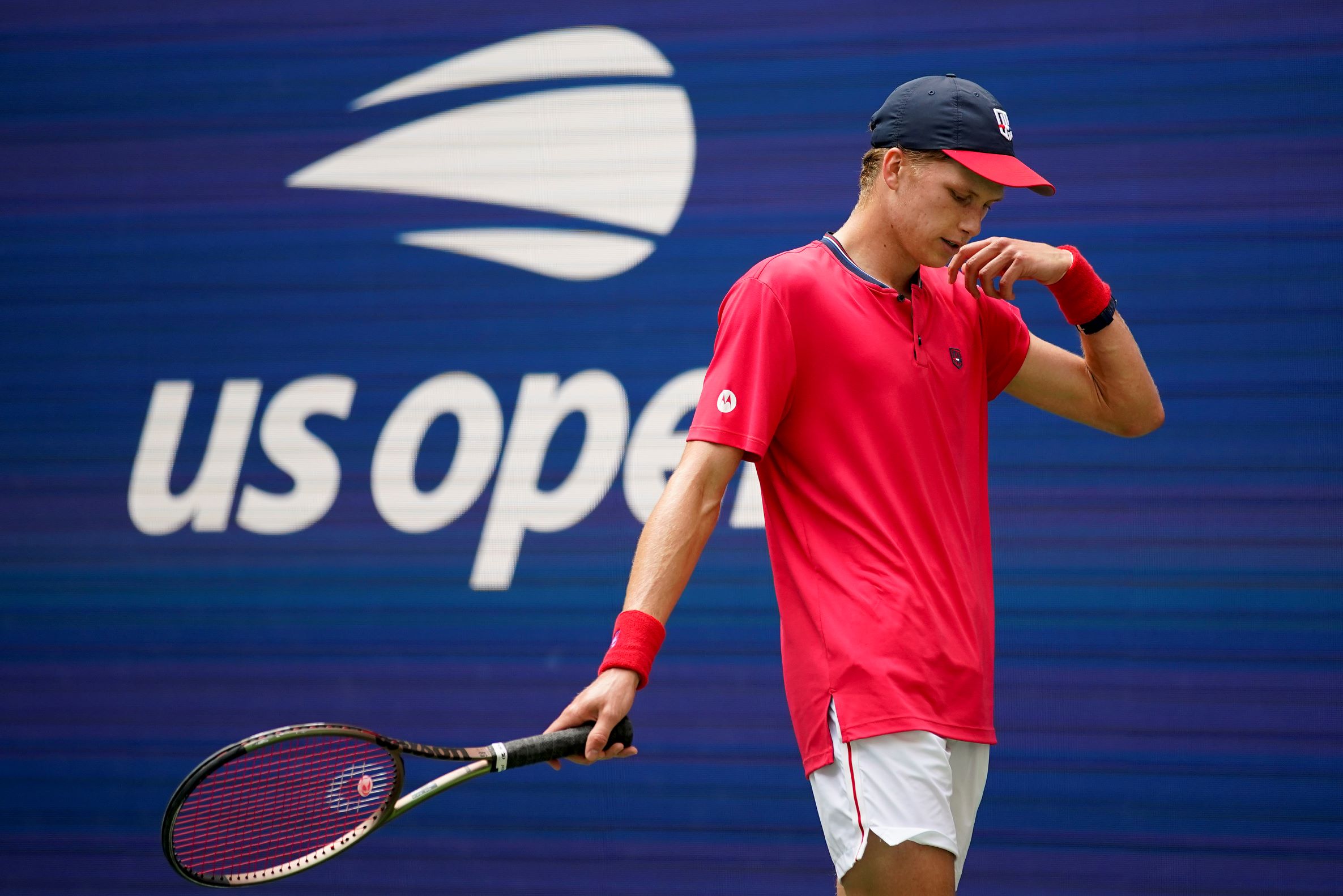 Jenson Brooksby, of the United States, reacts during a match against Carlos Alcaraz, of Spain, during the third round of the U.S. Open tennis championships, Saturday, Sept. 3, 2022, in New York. Brooksby was given an 18-month suspension after an independent tribunal determined he missed three drug tests within the span of a year. Under antidoping rules, athletes can be penalized without a positive test if they have three “whereabout failures” within 12 months. (AP Photo/Eduardo Munoz Alcaraz, File) Brooksby-Doping Suspension Tennis