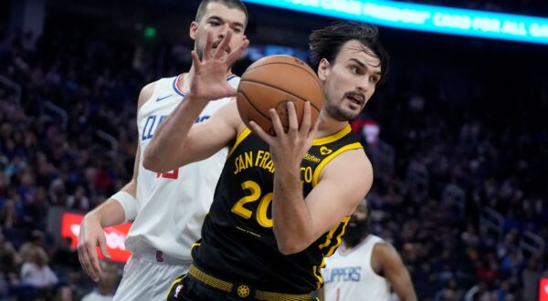 Golden State Warriors forward Dario Saric, foreground, is defended by Los Angeles Clippers center Ivica Zubac during an NBA basketball game in San Francisco, Wednesday, Feb. 14, 2024. (AP Photo/Jeff Chiu) Clippers Warriors Basketball