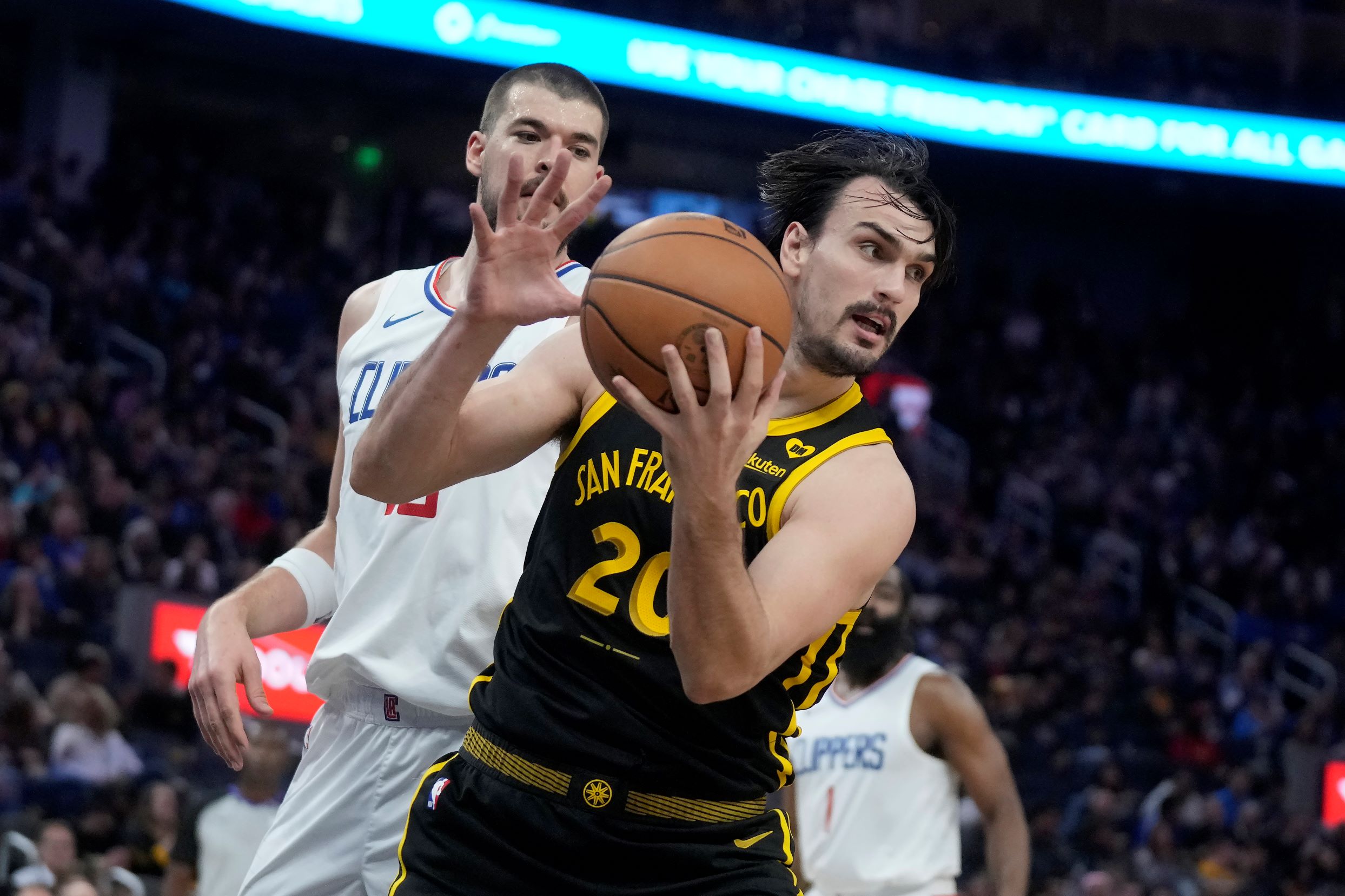 Golden State Warriors forward Dario Saric, foreground, is defended by Los Angeles Clippers center Ivica Zubac during an NBA basketball game in San Francisco, Wednesday, Feb. 14, 2024. (AP Photo/Jeff Chiu) Clippers Warriors Basketball